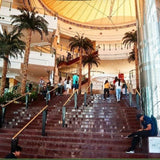 Group of tourists enjoying a cultural experience during a city tour, with traditional architecture and bustling markets.1
