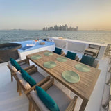Luxury houseboat docked in Qatar featuring spacious decks, a Jacuzzi, and outdoor seating for a relaxing sea escape.