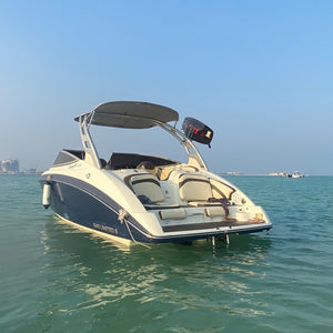 Passengers enjoying the thrill of a jetboat adventure with water splashing on all sides.