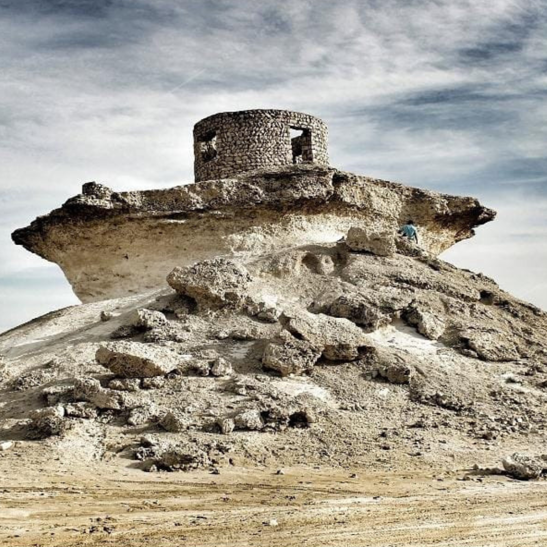 Scenic view of the Rock Umbrella Mountains during the West Coast Tour in Qatar, featuring dramatic landscapes.