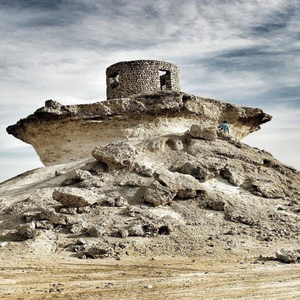 Scenic view of the Rock Umbrella Mountains during the West Coast Tour in Qatar, featuring dramatic landscapes.